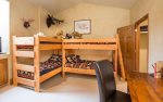 4th bedroom with two sets of twin bunk beds and en suite full bathroom.